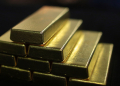 Gold bars sit in a stack as an employee pours molten fine gold into an ingot mold during gold bar production at Oegussa GmbH's gold and silver separating plant, a unit of Umicore SA, in Vienna, Austria, on Friday, Jan. 16, 2015. The Swiss central bank's surprise move to abandon the franc's cap against the euro sent investors rushing to gold as a haven from swings in currencies. Photographer: Lisi Niesner/Bloomberg